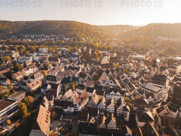 Panorama of a city in autumn with churches and diverse architecture from the air, Nagold, Black Forest, Germany