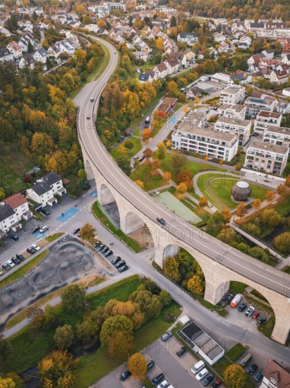 Viaduct runs through a small town surrounded by forests in autumn colors, Nagold, Black Forest, Germany