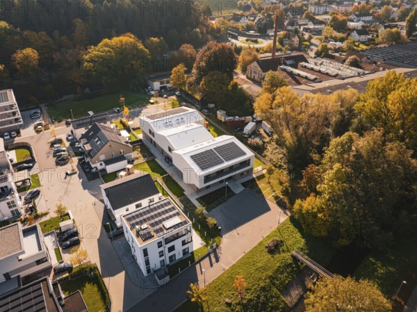 Picturesque overview of a small settlement with solar panels on the roofs in autumn surroundings, Nagold, Black Forest, Germany