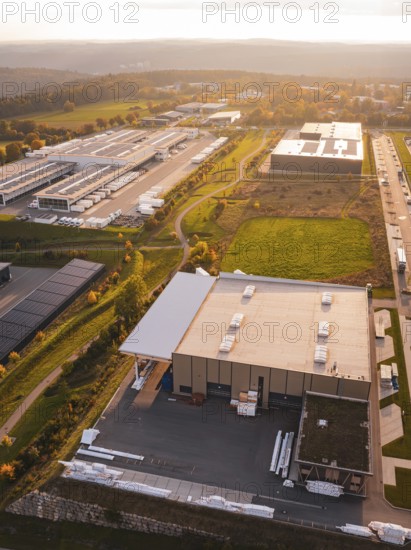 Industrial plants in autumn landscape at setting sun, Nagold, Black Forest, Germany