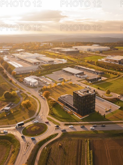 Roundabout and industrial park, in golden evening light, surrounded by fields and nature, Nagold, Black Forest, Germany