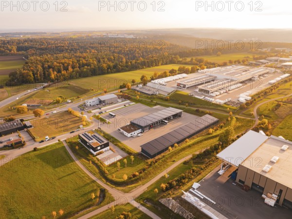 Industrial area on the edge of the forest, seen from above in autumn light, Nagold, Black Forest, Germany