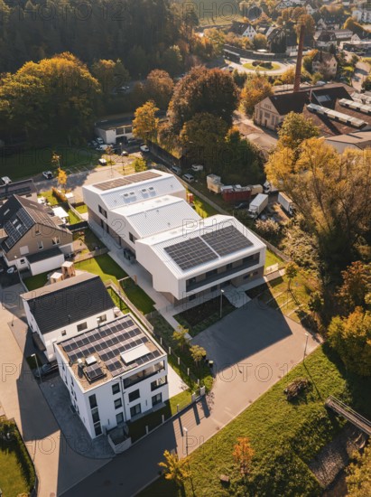 Aerial view of a modern settlement with solar panels in autumn light, Nagold, Black Forest, Germany