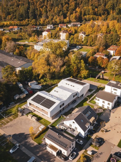 Residential area with modern buildings and solar panels, surrounded by autumnal nature, Nagold, Black Forest, Germany