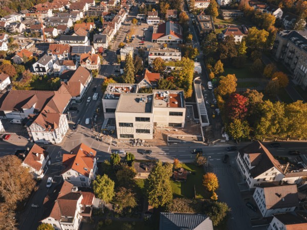 Urban aerial view with autumn trees and winding roads in the sun, Nagold, Black Forest, Germany