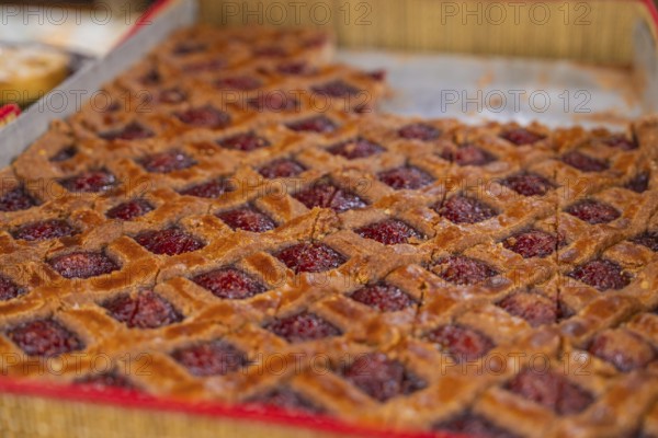 Large raspberry cake with grid pattern presented on a tray, Streuobstmarkt, Sindelfingen, Böblingen district, Germany