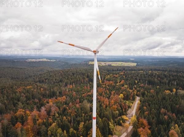 Wind turbine above a forest in autumn colors, with a wide view, Simmersfeld wind farm, Germany