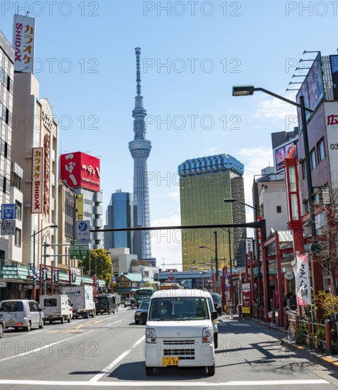 Street with typical Japanese houses, Sumida City skyline in the back, Sumida City Office, Tokyo Skytree, and Asahi Headquarters, Asakusa, Tokyo, Japan