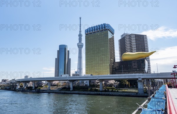 View of the Sumida River from Azuma Bridge, Sumida City Skyline, Sumida City Office, Tokyo Skytree, Asahi Beer Hall and Asahi Headquarters with Asahi Flame, Asakusa, Tokyo, Japan