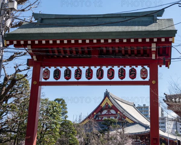 Red gate with lanterns, red and gold roof gable of a temple building, Buddhist temple complex, Asakusa shrine or Senso-ji temple, Asakusa, Tokyo, Japan