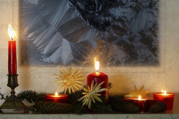 Christmassy decorated iced window, candle light, straw stars, Germany