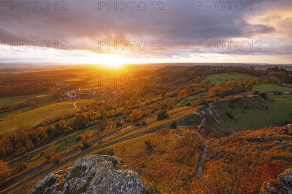 Low sun shines in the Spielburg Nature Reserve, Hohenstaufen, Göppingen, Baden-Württemberg, Germany. Indian summer over the rocks of the Swabian Jura