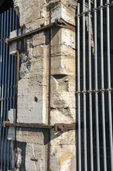 Pillar element made of travertine stone from Colosseum with architectural measure used in the construction of Amphiteatrum Flavium iron clips in masonry for stability strength cohesion, Rome, Lazio, Italy