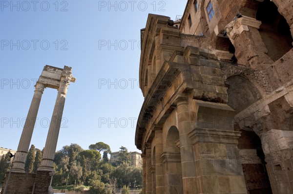 Center and right part of preserved façade of historic ancient Marcellus Theatre, left ruin of ancient columns from the Temple of Apollo, Rome, Lazio, ItalyRome, Lazio, Italy