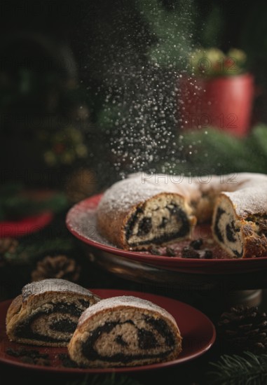 Icing sugar falls on poppy seed cake on red plate surrounded by Christmas decorations