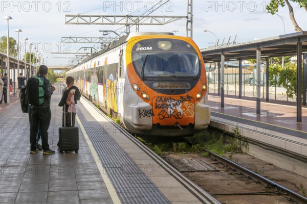 Renfe Civia commuter train at platform of Airport railway station, Rodalia de Barcelona suburban rail network, Barcelona, Catalonia, Spain
