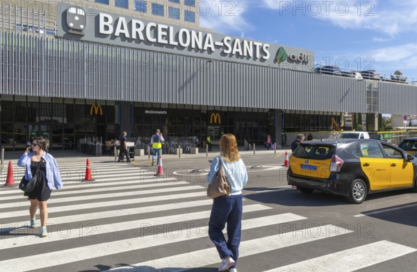 Taxis in street outside Barcelona-Sants railway station building in city centre, Barcelona, Catalonia, Spain
