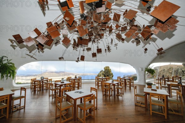 Interior of café with panoramic window in building designed by Cesar Manrique with the collaboration of Jesús Soto and architect Eduardo Caceres without right angles corners on viewpoint tourist attraction El Mirador del Río on the summit of the 474 meter high Risco de Famara in Famaramassiv with panoramic view of the Chinijo Archipelago, La Graciosa island, Lanzarote, Canary Islands, Canary Islands, Spain