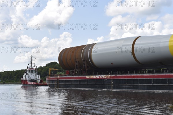 Tugboat, tow ship pulls parts of a wind turbine, offshore, in the Kiel Canal, NOK, Kiel Canal, Schleswig-Holstein, Germany