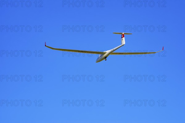A DG Flugzeugbau glider DG-1000, registration HB-3361, during a demonstration as part of an air show at the Fliegerbergfest of the Rossfeld Luftsportverein in Metzingen-Glems, Baden-Württemberg, Germany, for editorial use only