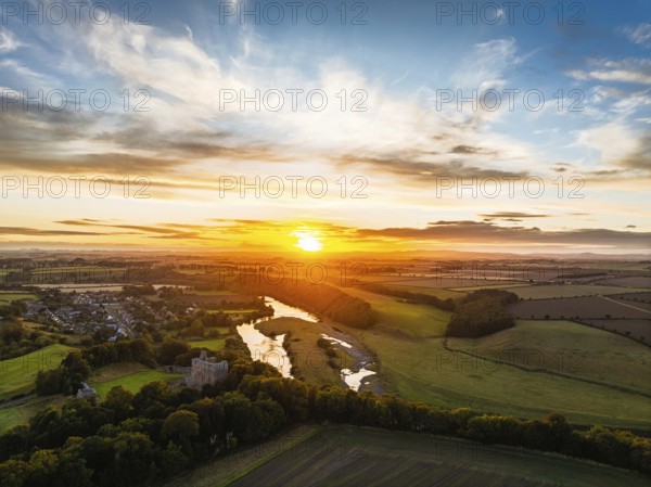 Sunset over Norham Castle and River Tweed from a drone, Norham, Northumberland, England, United Kingdom