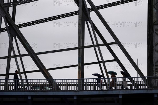 Passers-by with umbrella on a bridge, autumn, rainy weather, Germany