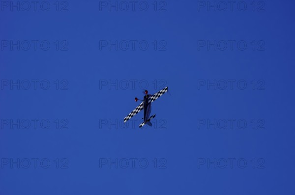A single-engine aerobatic aircraft during a flight demonstration at the Rossfeld Luftsportverein in Rossfeld in Metzingen-Glems, Baden-Württemberg, Germany, for editorial use only