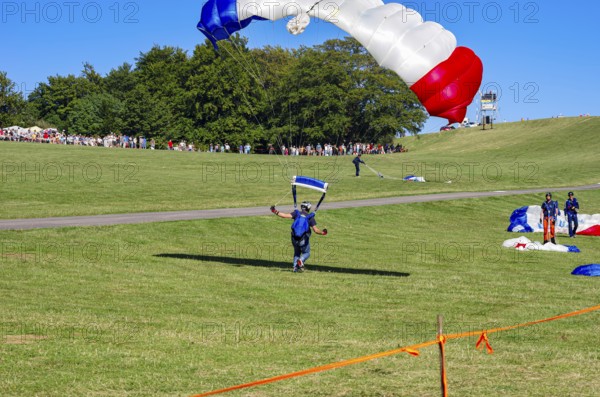Landing of skydivers during an aerial acrobatic performance as part of an air show at the Rossfeld Air Sports Association Air Sports Festival on Rossfeld in Metzingen-Glems, Baden-Württemberg, Germany, for editorial use only