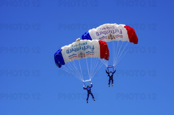 Skydivers during an aerial acrobatic performance as part of an air show at the Fliegerbergfest of the Rossfeld Luftsportverein in Metzingen-Glems, Baden-Württemberg, Germany, for editorial use only