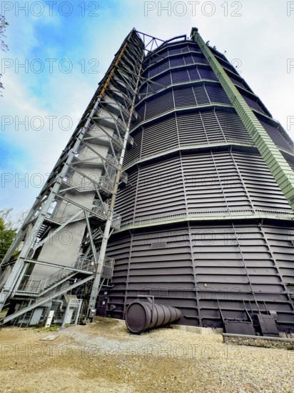 View steeply upwards on the outside of former Gasometer Oberhausen today exhibition venue, external staircase on the left, North Rhine-Westphalia, Germany