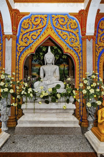 Small altar small pedestal with statue of Buddha Buddha statue in worship room room for worship in Wat Chalong temple complex, Wat Chaithararam, Phuket island, Phuket province, Thailand