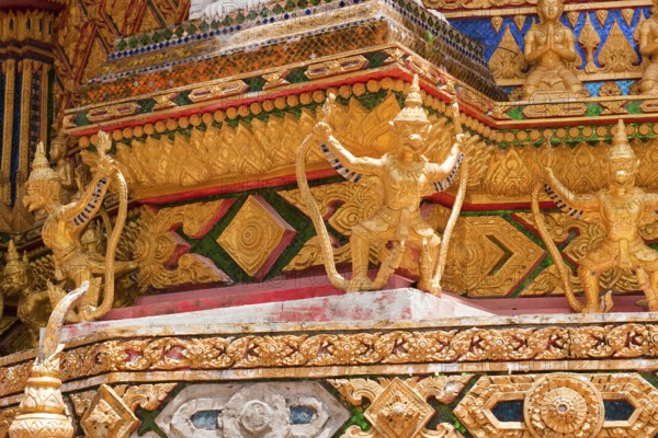 Gilded gold-colored statues figures of Buddhist temple guards mystical guards at Buddhist temple Wat Bang Riang, Thap Put, Amphoe Hap Put, Phang Nga Province, Thailand