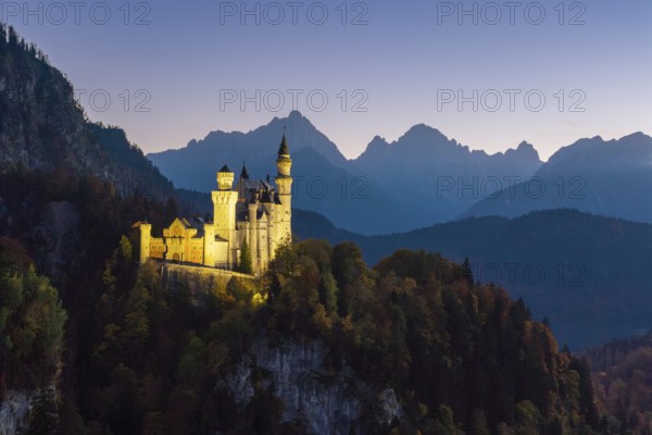 Romantic Neuschwanstein Castle at dusk in front of Bergen, Schwangau near Füssen, Ostallgäu, Allgäu, Bavaria, Germany