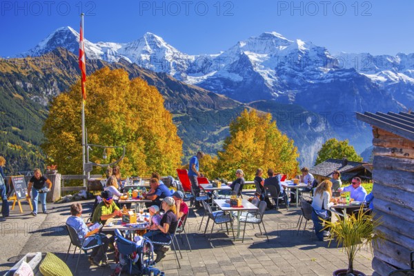 Sun terrace of the mountain inn in the hamlet of Sulwald with Eiger 3967m, Mönch 4110m and Jungfrau 4158m in autumn, Isenfluh, Lauterbrunnental, Bernese Oberland, Canton of Bern, Switzerland