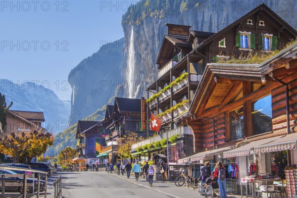 Village road with Staubbach waterfall, Lauterbrunnen, Bernese Oberland, Canton of Bern, Switzerland