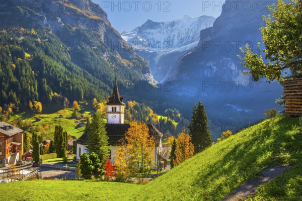 Village church in the town center with fieschörner 4049m in autumn, Grindelwald, Lütschinental, Bernese Oberland, Canton of Bern, Switzerland