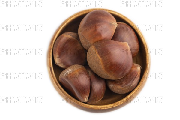 Wooden bowl with raw edible ?hestnuts Isolated on white background, top view, flat lay, close up, minimalism