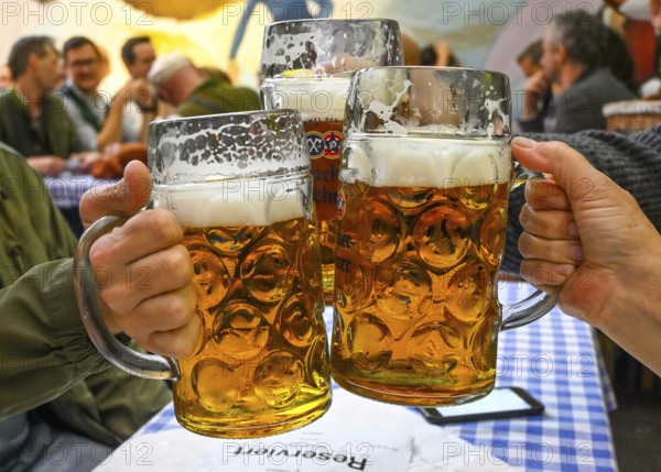 Guests toast with beer mugs, beer mug, Hacker-Pschorr party tent, Bavarian sky, Oktoberfest, Munich, Bavaria, Germany