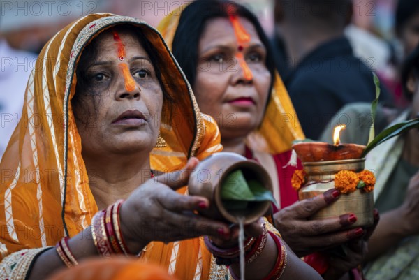 Hindu devotees offer prayers to the Sun God on the bank of Brahmaputra river on the occasion of Chhath Puja, in Guwahati, India on 27 October 2025