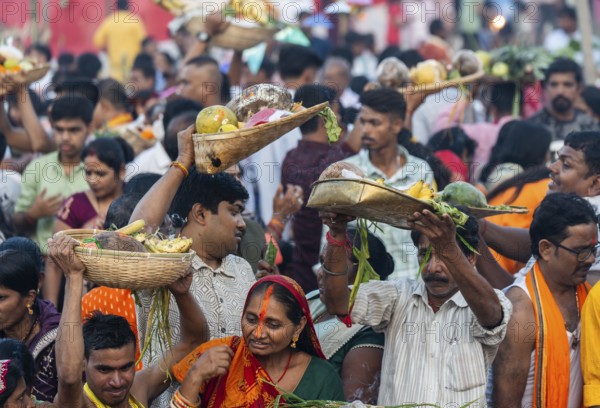 Hindu devotees gather on the banks of the Brahmaputra River to offer prayers to the Sun God on the occasion of Chhath Puja, in Guwahati, India on 27 October 2025