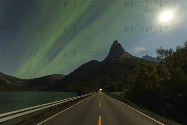 Magical Stetind mountain in northern Norway under auroras and full moon