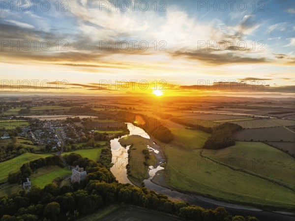 Sunset over Norham Castle and River Tweed from a drone, Norham, Northumberland, England, United Kingdom