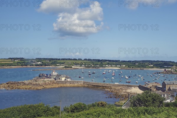 Harbour landscape with boats on water and coast in the background, Isles of Scilly, Cornwall, Great Britain