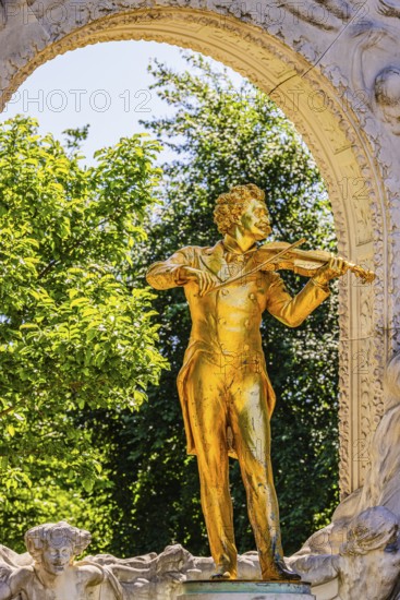 The gilded bronze statue of Johann Strauss, the Waltz King, memorial in the municipal park, Vienna, Austria