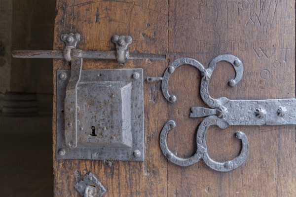 Detail of an old wooden door with metal fittings and lock in a rustic, historic atmosphere, Eberbach Abbey, Eltville, Rheingau, Hesse, Germany