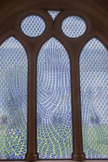 Colourful stained glass window with geometric patterns, the Pietà window by Thomas Bayrle, in the cloister of Eberbach Abbey, former Cistercian Abbey, Eltville, Rheingau, Hesse, Germany