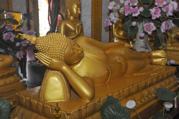 Reclining Buddha in golden color resting head on hand Unteram, Wat Chalong Monastery, Phuket Island, Phuket Province, Thailand
