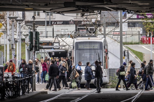 Pedestrians cross the tram tracks, at Düsseldorf-Bilk station, junction of S-Bahn, subway, tram, local bus transport, North Rhine-Westphalia