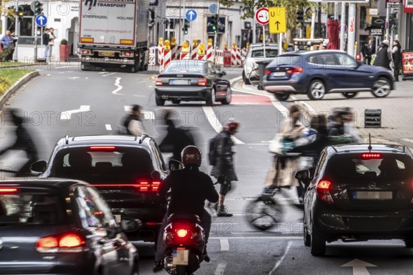 Pedestrians at Düsseldorf-Bilk train station, cross Friedrichstraße at a pedestrian crossing with traffic lights, North Rhine-Westphalia