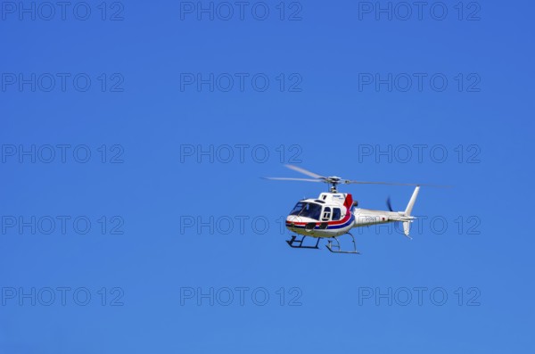 An Aerospatiale AS-350 BA Ecureuil helicopter, registration D-HAAN, from Meravo Air Company during a flight demonstration as part of an air show on Rossfeld in Metzingen-Glems, Baden-Württemberg, Germany, for editorial use only
